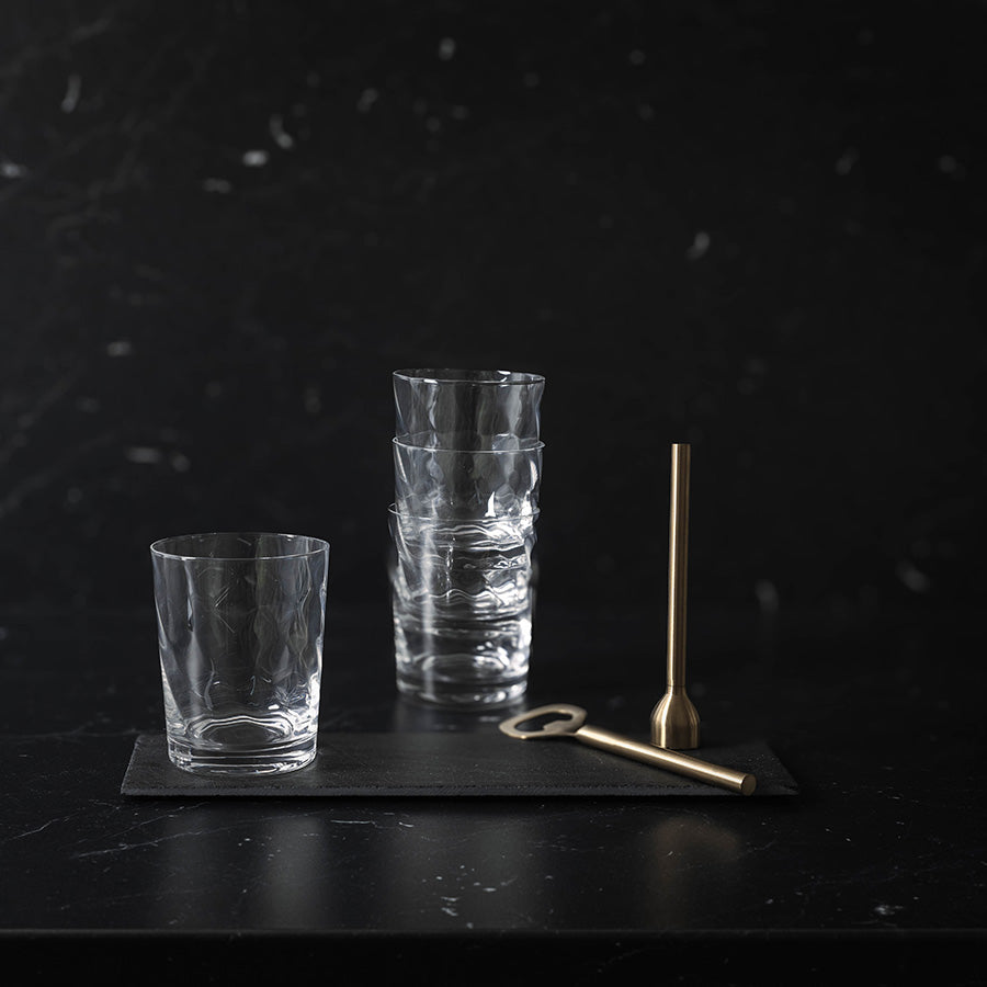 Vannglass stablet pent på en svart skiferplanke, fremhever deres stilige karakter.