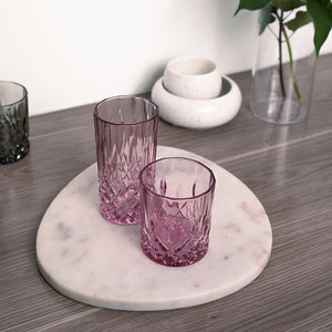 Rosa longdrinkglass med dekorativt krystallmønster, 300 ml, på marmorbrett