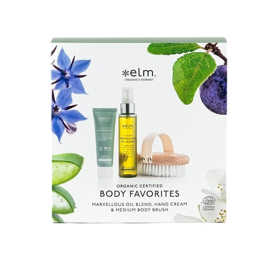 Elm Organics Body Favorites Gaveeske med kroppsolje, håndkrem og tørrbørste for en komplett velværeopplevelse, dekorert med naturlige ingredienser.