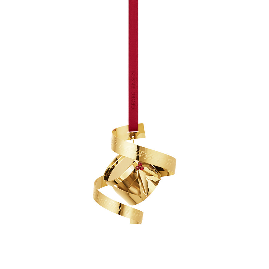 Georg Jensen juleuro 2026 formet som en tromme med notebånd i 18 kt forgylt messing