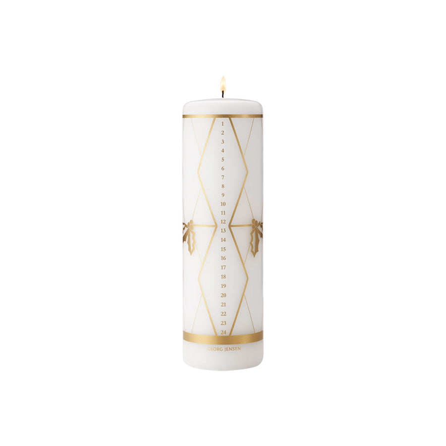 Georg Jensen kalenderlys 2026 med gullfargede motiver av kristtorn og tromme