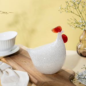 Hadeland Glassverk høne i kunstglass, plassert på en treplate, med vakre detaljer og en moderne stil. Ideell for dekorasjon til påske.