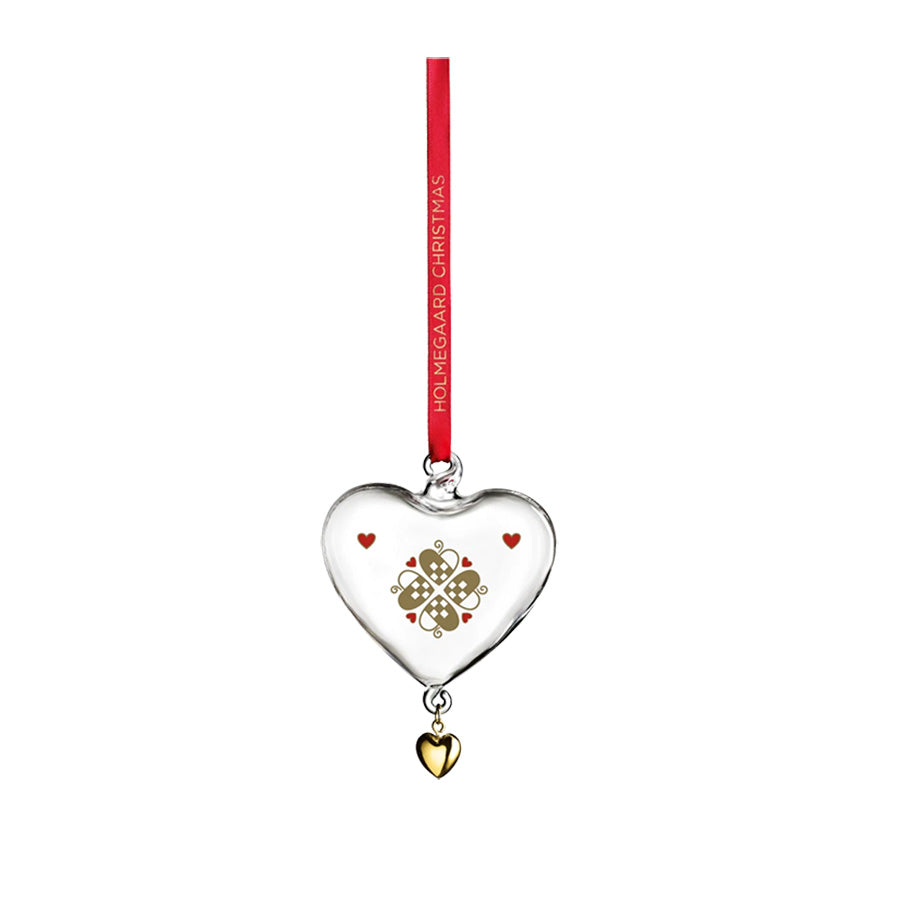 Holmegaard julehjerte i munnblåst glass med gylne detaljer, hengende med rød silketråd. Perfekt ornament for juletreet.