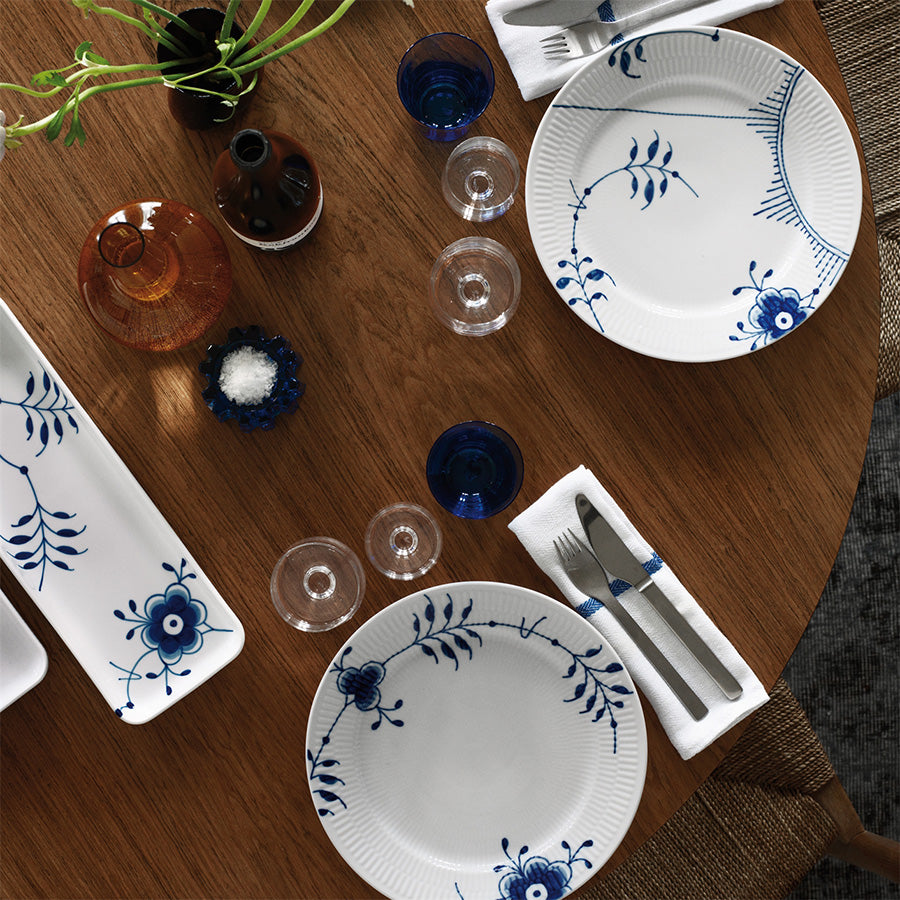 Royal Copenhagen Blå Mega Riflet Fat, 36 cm serveringsfat sett fra oven, anrettet med tallerkener og glass, skaper en elegant bordsetting.