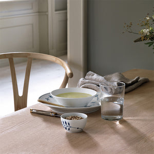 Royal Copenhagen Hvit Riflet Dyptallerken 17cm - Dyptallerken som serverer suppe med detaljert bordsetting, ideell for en elegant middag.
