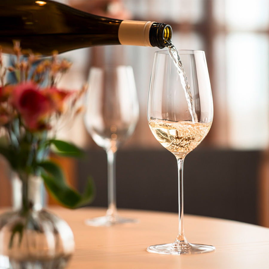 RIEDEL Veritas Riesling/Zinfandel 2pk 270-årsjubileum – RIEDEL Veritas-glass der vin heller fra flaske, elegant borddekking