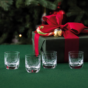 Fire Villeroy & Boch Toy's Delight shotglass med julemotiv foran en innpakket julegave