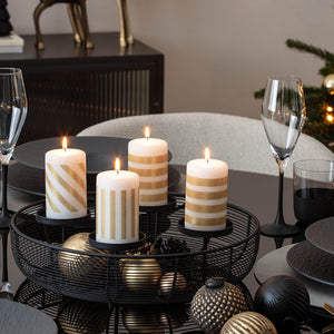 Elegant adventsstake med fire tente kubbelys på festdekket julebord