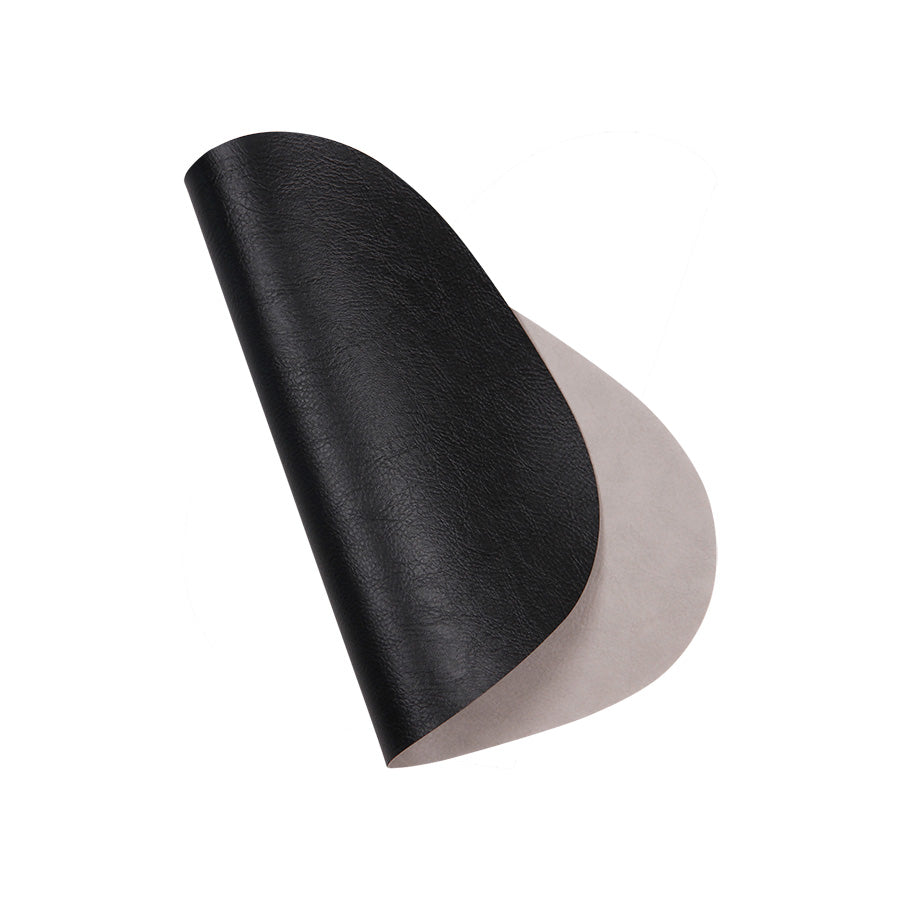 Reversibel spisebrikke i eggform med svart og grå overflate, perfekt for borddekorasjon.