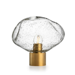 Hadeland Glassverk Crystal Stone bordlampe i klar m/soda med gullfarget base og munnblåst glass, skaper et vakkert lysspill.