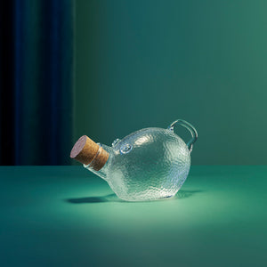 Dekorativ Godtegris krukke i klart glass med korkpropp, vist i stemningsfull belysning