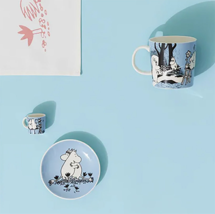 Samling av Moomin Arabia minikopper og tallerkener i blått med Mummi-motiv, flott som dekor eller gave.