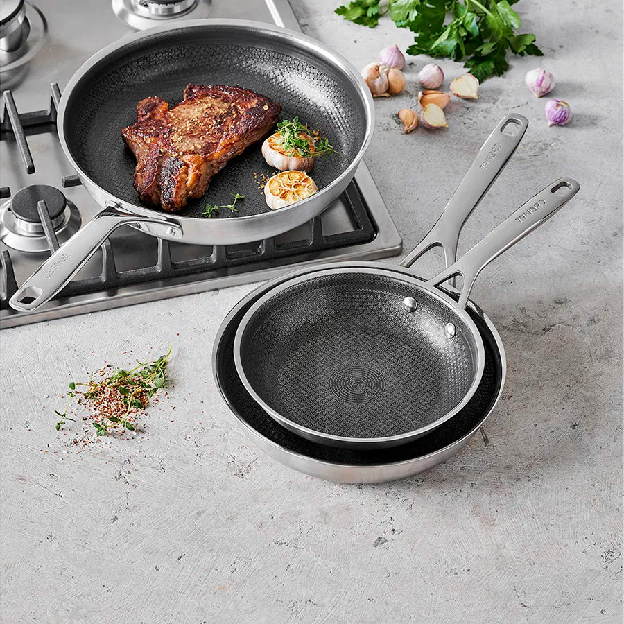 To Morsø 79Nord stekepanner 24 cm og 20 cm, med stekt biff, plassert på en gasskomfyr, perfekt for allsidig matlaging.