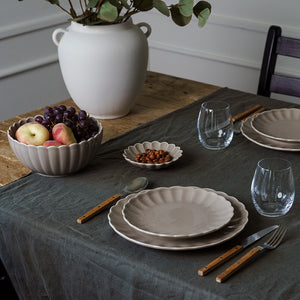 Stilig bordinnstilling med Nova Lilly tallerken, bolle og glass, fremhever tallerkenens delikate gråfarge.