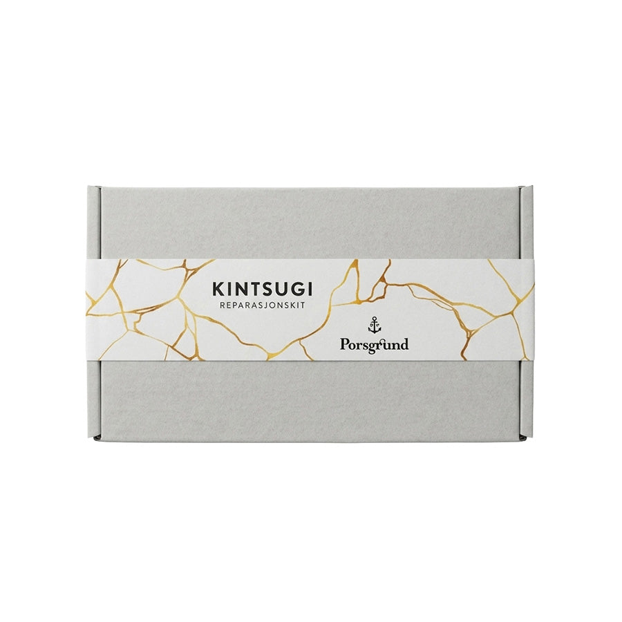 Porsgrunns Kintsugi kit med elegant eske, designet for reparasjon av keramikk med gullfargede linjer.