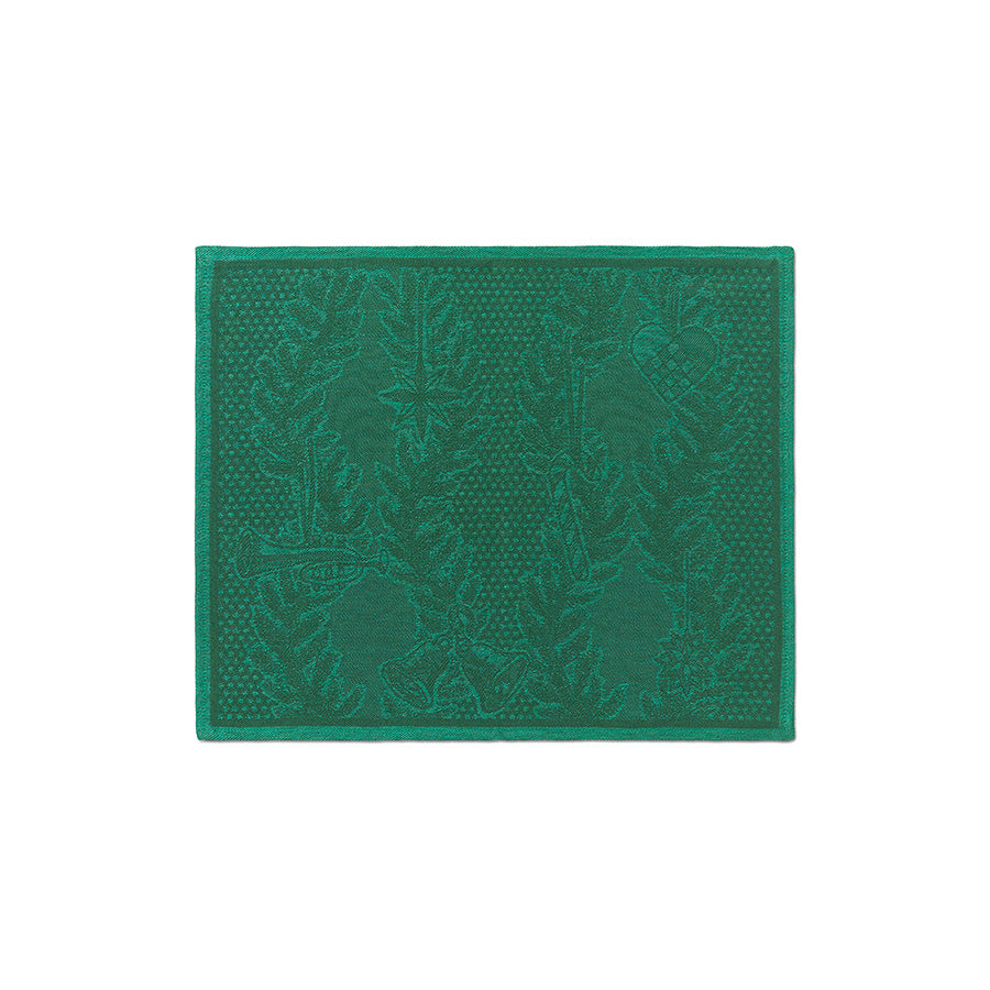 Detaljert bilde av en bordbrikke fra Royal Copenhagen i dyp grønn farge, med jacquardvevd mønster og subtile julemotiver, ideell for å skape julestemning.