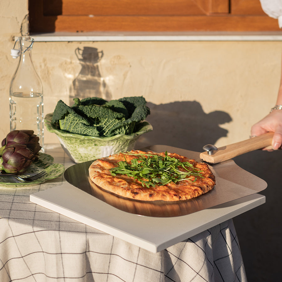 Seasons BBQ Pizzasten for Grill 38x30cm - pizzasten under en ferdiglaget pizza, viser bruk av pizzasten til grilling.