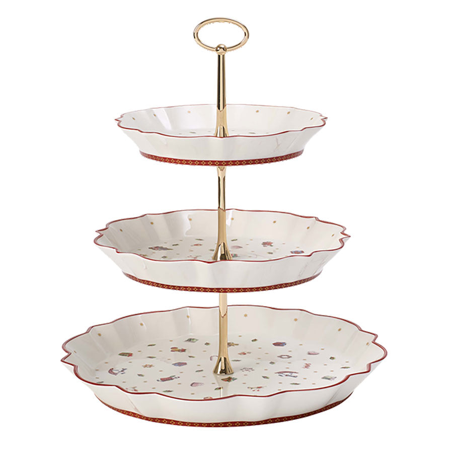 Villeroy & Boch Toys Delight etasjefat med tre nivåer, dekorert med nostalgiske julemotiver og gullfarget stativ, perfekt for servering av julekaker.