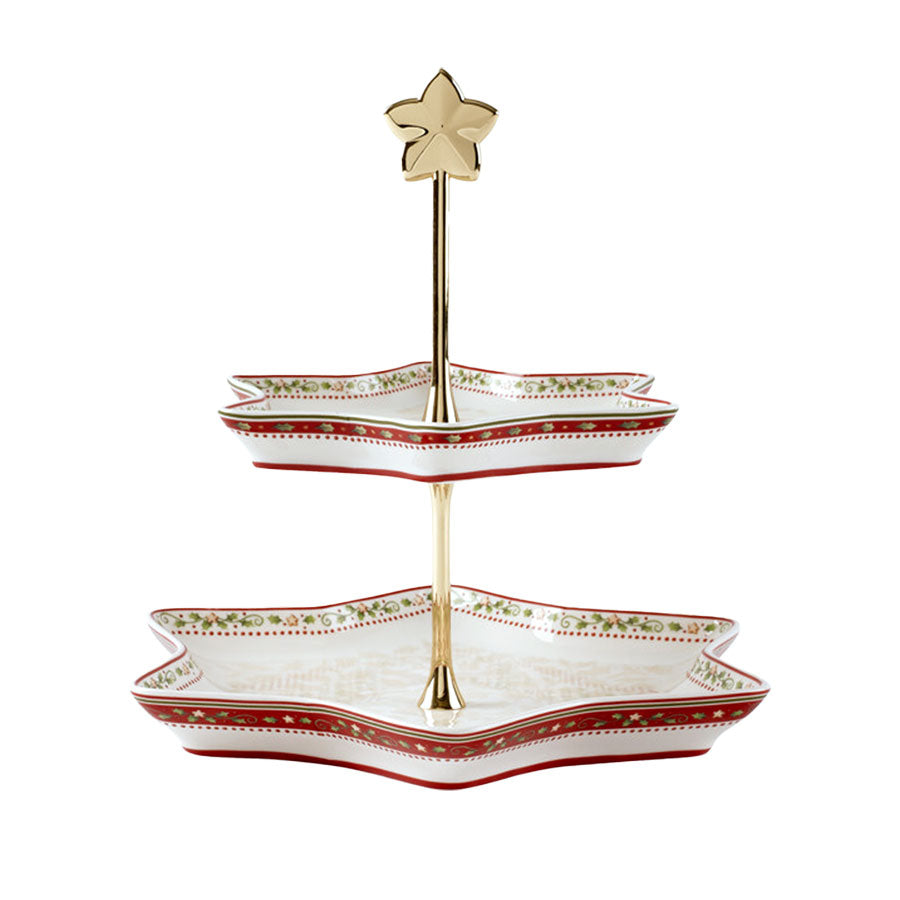 Villeroy & Boch Winter Bakery Delight etasjefat med to etasjer i stjerneform, dekorert med julemotiver og gylden stjerne i toppen. Perfekt for servering av småkaker og julestemning.